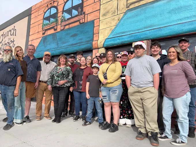 The Standard's staff and family gathered outside the office in downtown Kingman